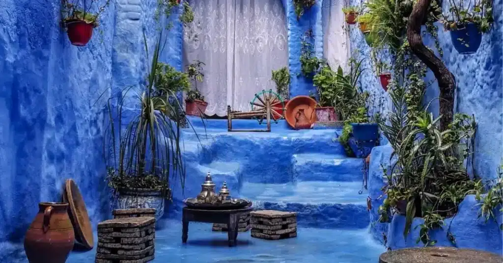 Traditional blue-washed stairs and tea setup in Chefchaouen, Morocco tours 2025 cultural stop