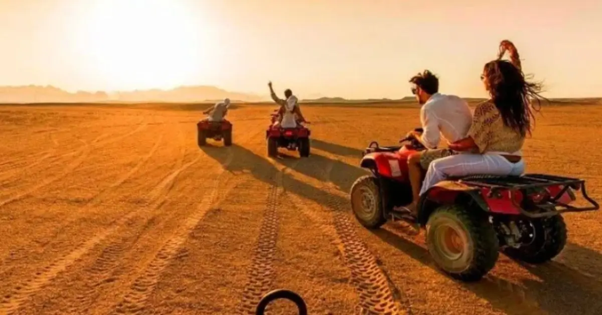 ATV riders exploring the Moroccan desert at sunset