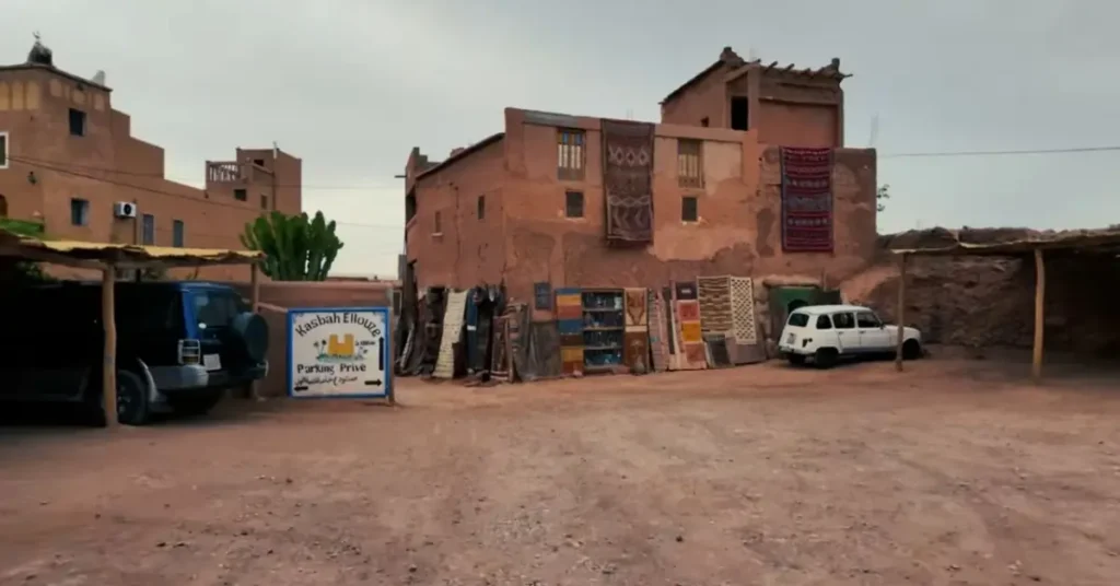 Traditional mudbrick building near Ait Ben Haddou with Berber carpets on display