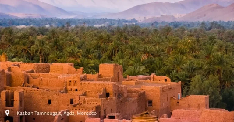 Kasbah Tamnougalt in Agdz surrounded by palm groves and Atlas Mountains in Morocco