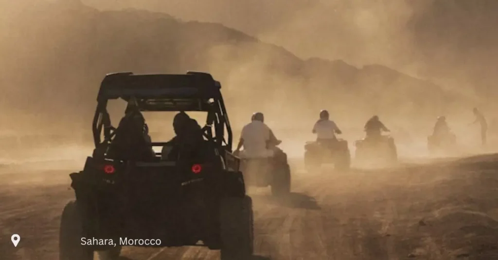 Adventurers riding ATVs through the dust trails of the Moroccan Sahara