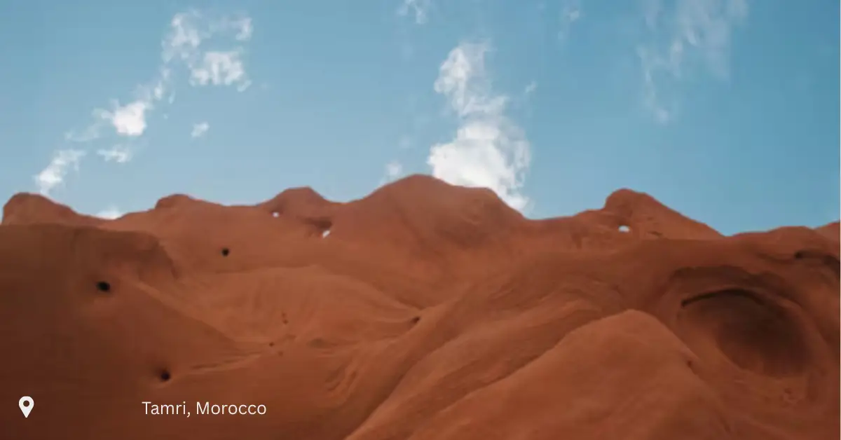 Wind-carved red rock formations under a blue sky in Tamri, Morocco morocco tours