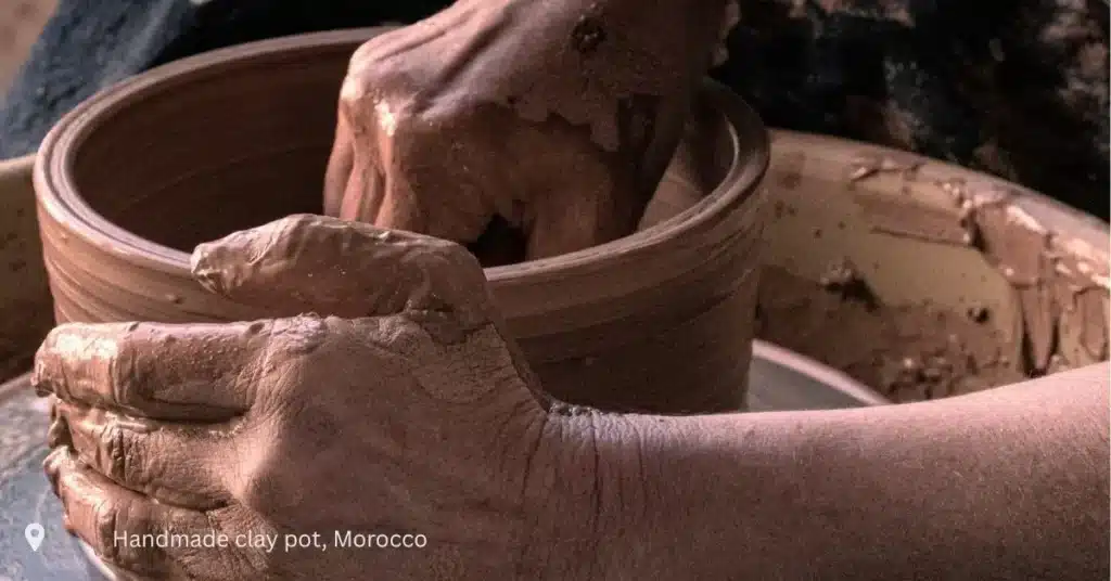 Moroccan artisan shaping handmade clay pot – cultural experience in Morocco small group tours