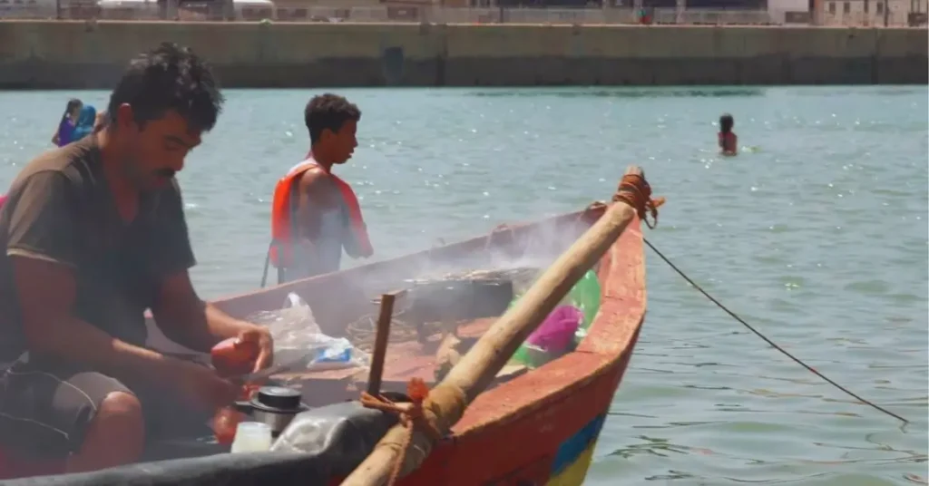 Grilling sardines on a fishing boat in the Bou Regreg, Rabat